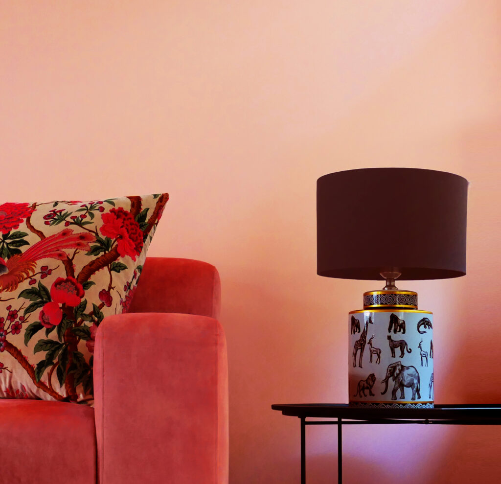 Cozy interior showing lamp a a sofa and a pillow with floral pattern.